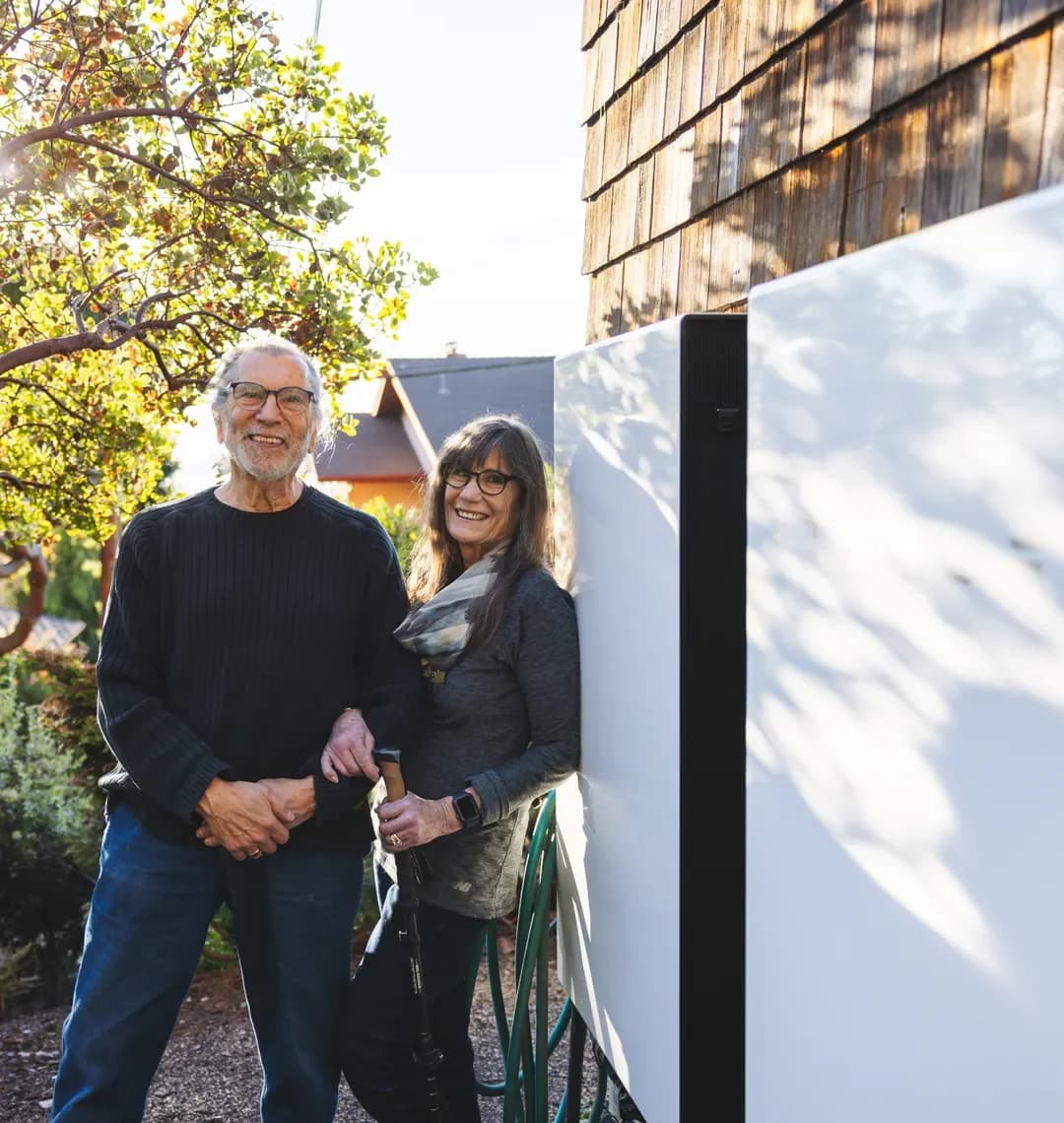 Haven customers standing beside their home battery